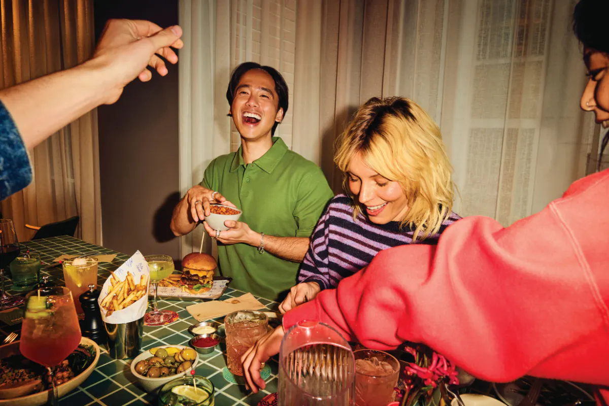Pair enjoying food at lively restaurant
